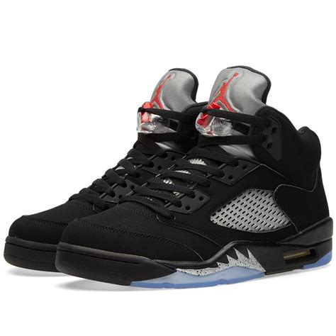 Matching blue embroidery appears on each heel overlay, featuring a Nike Air logo on the right. . Jordan air 5